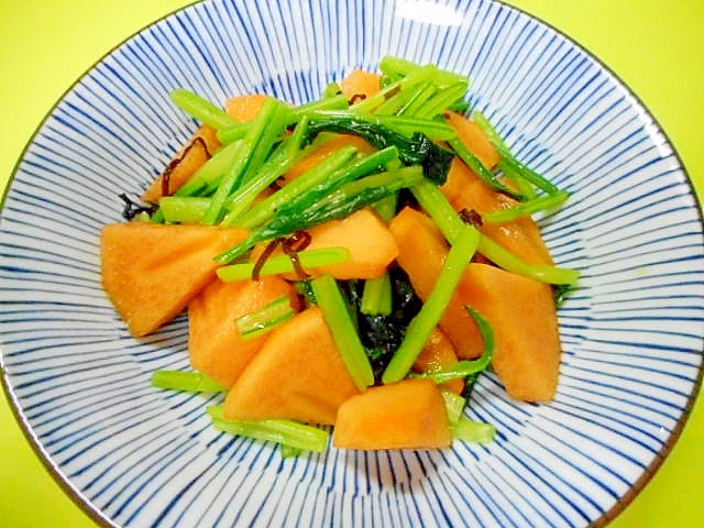 青い線模様の皿に盛りつけられた柿と壬生菜の塩こんぶ和え