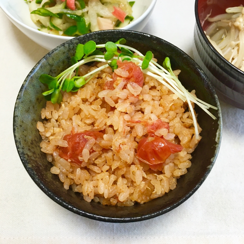 黒い茶碗に盛られたツナ缶とミニトマトの炊き込みごはん