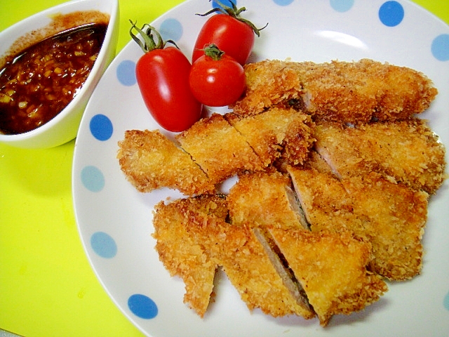 白い丸皿に盛り付けた塩麹とんかつのはっさくソース添え