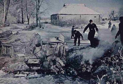 The crew of a Pzkw III thaw the frozen mud around their tank -- vehicles stuck in the autumn were practically cemented in by the.jpg