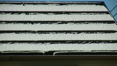屋根の太陽光発電パネルに積もった雪