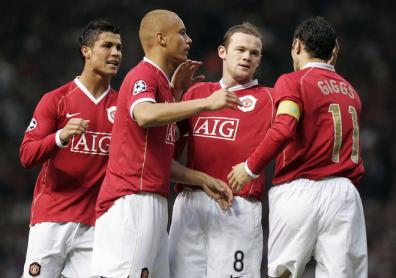 Wayne Rooney is congratulated by team mates after AC Milan conceeded a own goal during their European Champions League semi final first leg football match at Old Trafford.jpg
