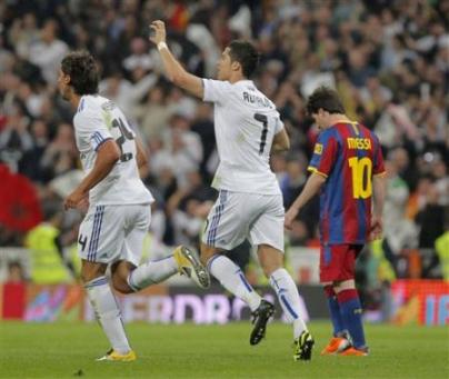 Cristiano Ronaldo celebrates his goal with Sami Khedira besides Lionel Messi during the Spanish La Liga soccer match against Barcelona at the Santiago Bernabeu.jpg
