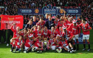 Manchester United celebrate with the Premier League trophy after the Barclays Premier League match between Manchester United and Blackpool at Old Trafford.jpg