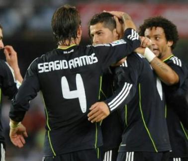 Real Madrids players congratulate Cristiano Ronaldo after Pepe scored thanks to a kick from Ronaldo during a Spanish league football match against Real Sociedad.jpg