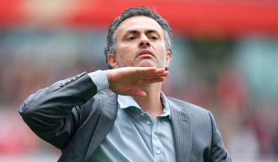 Jose Mourinho motions for fans to keep their chins up to not be disheartened after they drew 1-1 with Arsenal in their Premiership match at home to Arsenal at the Emirates Stadium.jpg