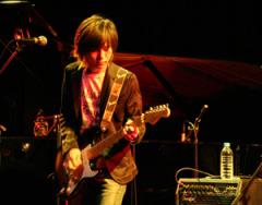 Simon plays electric guitar